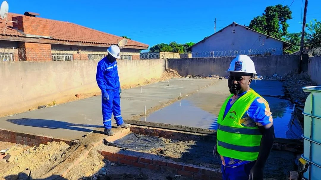 DC Designs and Construction site supervisor monitoring concrete slab works